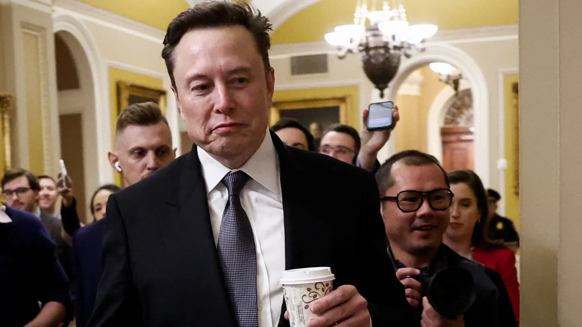 Elon Musk walks on Capitol Hill on the day of a meeting with Senate Republican Leader-elect John Thune